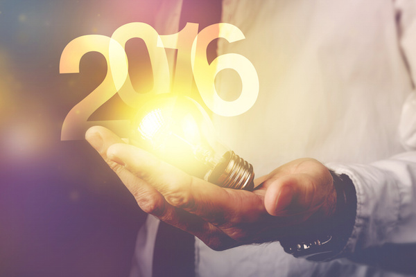 Happy new 2016 business year, businessman with light bulb and number 2016, retro toned image, selective focus.