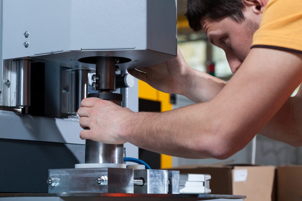 Worker programming machine in a factory, horizontal