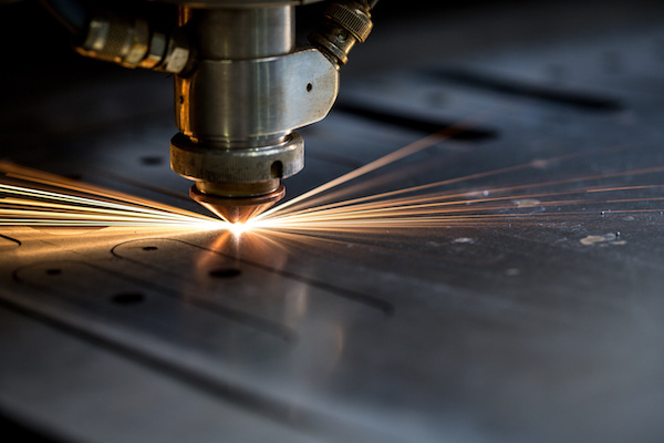Cutting of metal. Sparks fly from laser, close-up
