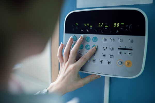 Industrial operator pressing a custom membrane switch control panel button