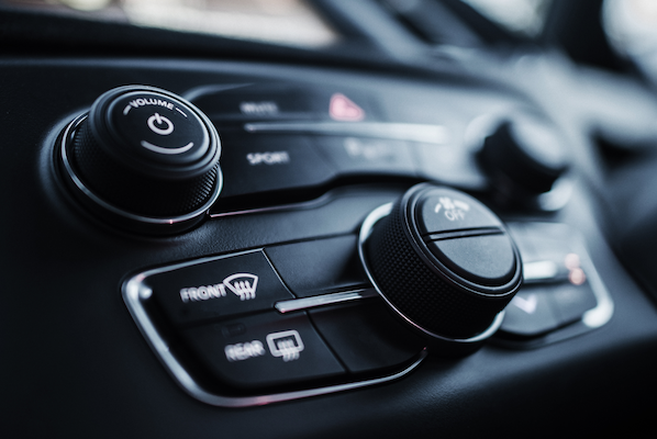 Automotive dashboard membrane switch controls for HVAC and infotainment showing low-profile vehicle interface design